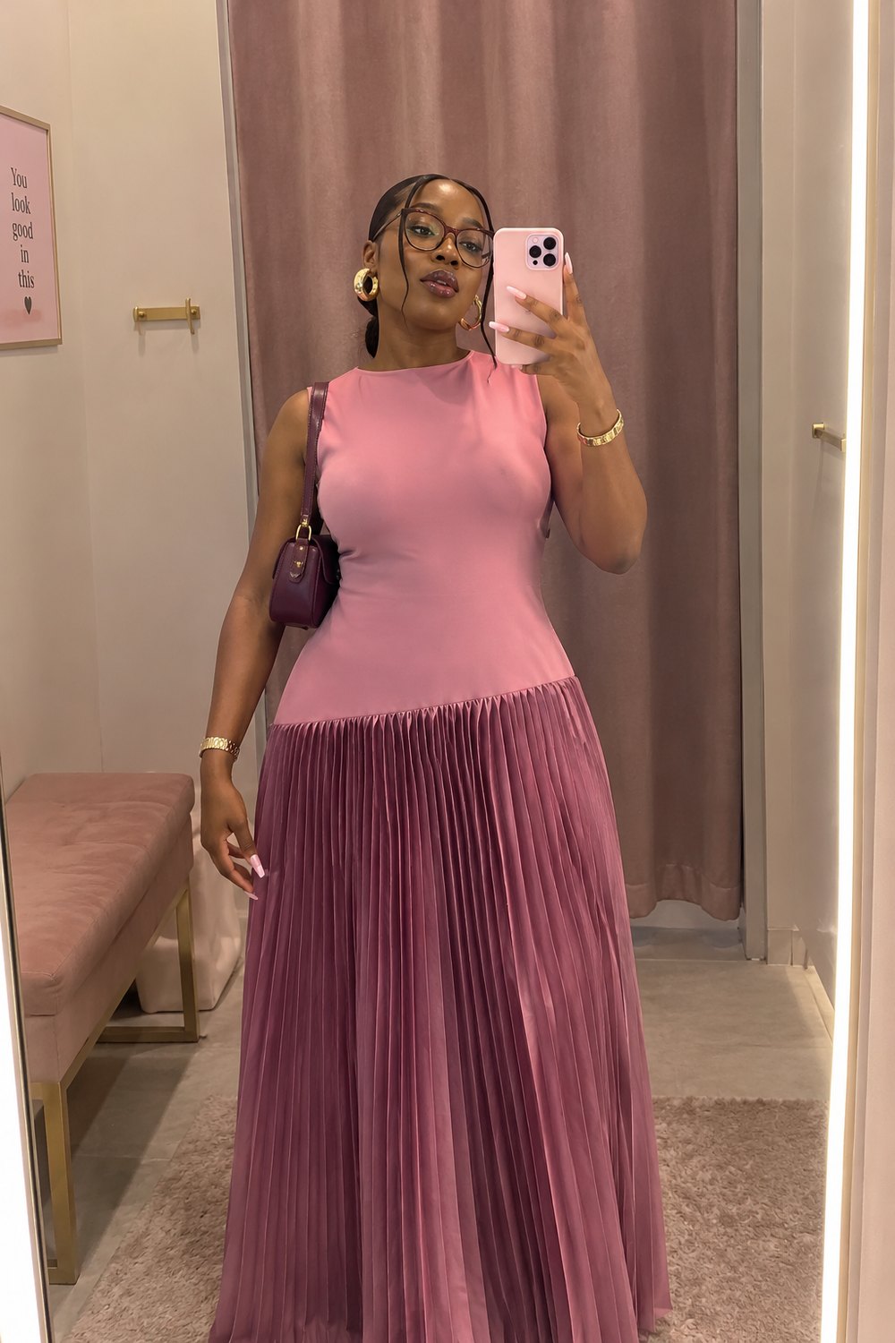 Woman in a pink pleated maxi dress